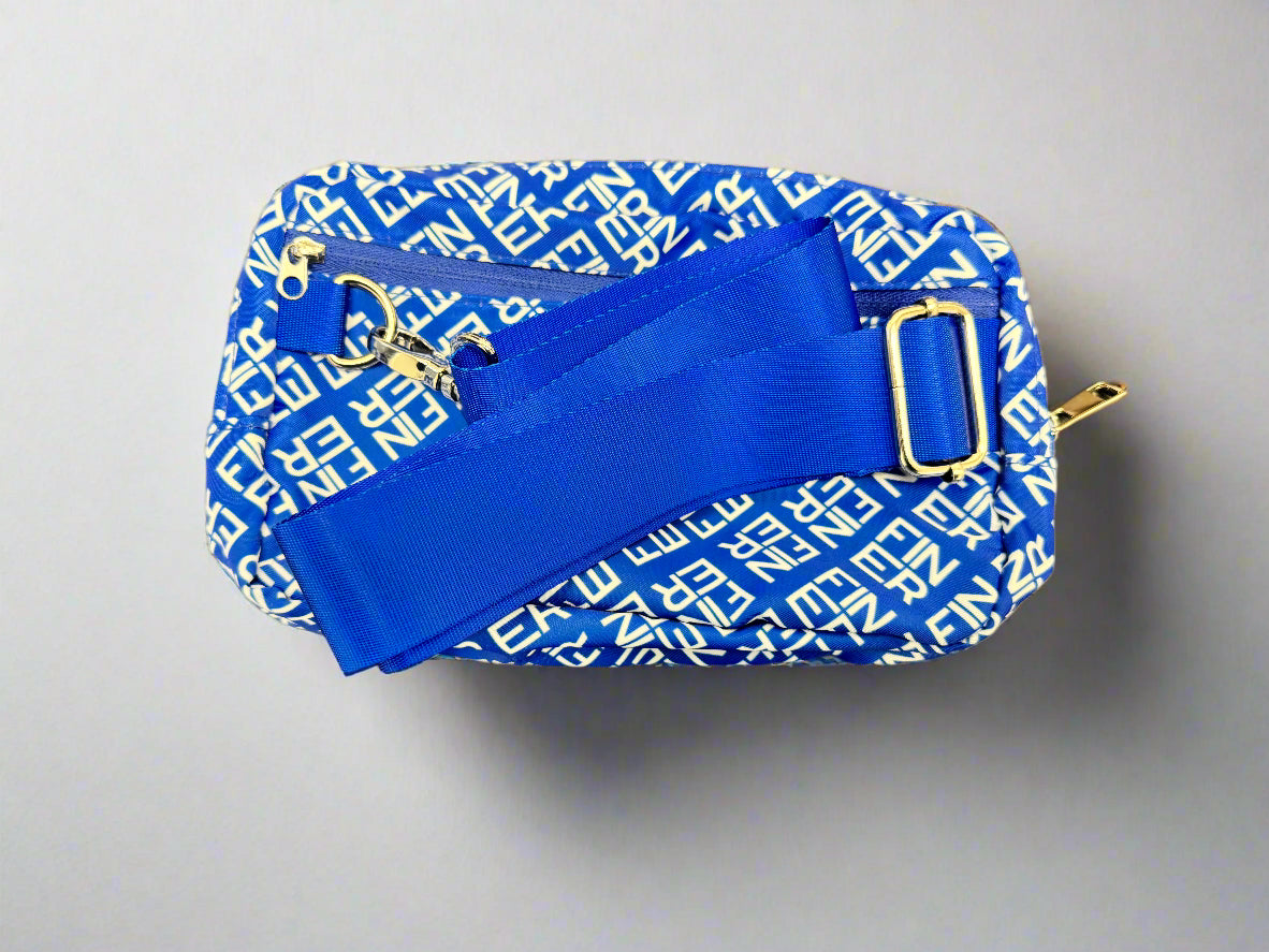 Blue and white patterned bag with silver hardware on a gray background